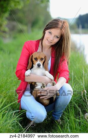 Close-up of a young woman with her Beagle dog in spring. View Large Photo Image Stock Photo - Close-up of a young woman with her Beagle dog in spring.. Fotosearch