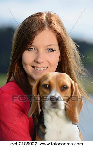 Close-up of a young woman with her Beagle dog in spring. View Large Photo Image Stock Photo - Close-up of a young woman with her Beagle dog in spring.. Fotosearch