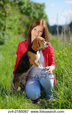 Close-up of a young woman with her Beagle dog in spring. View Large Photo Image Stock Photo - Close-up of a young woman with her Beagle dog in spring.. Fotosearch