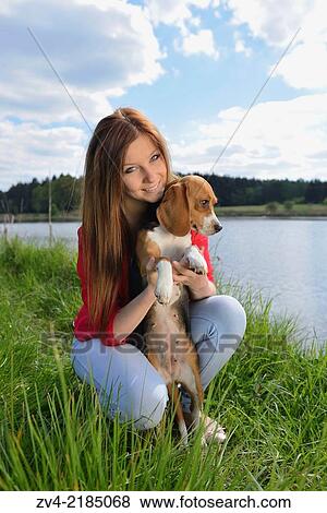 Close-up of a young woman with her Beagle dog in spring. View Large Photo Image Stock Photo - Close-up of a young woman with her Beagle dog in spring.. Fotosearch