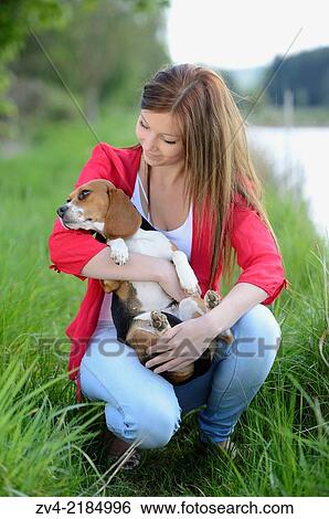 Close-up of a young woman with her Beagle dog in spring. View Large Photo Image Stock Photograph - Close-up of a young woman with her Beagle dog in spring.. Fotosearch