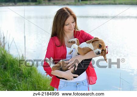 Close-up of a young woman with her Beagle dog in spring. View Large Photo Image Stock Photography - Close-up of a young woman with her Beagle dog in spring.. Fotosearch