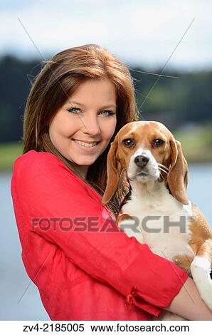 Close-up of a young woman with her Beagle dog in spring. View Large Photo Image Stock Photography - Close-up of a young woman with her Beagle dog in spring.. Fotosearch