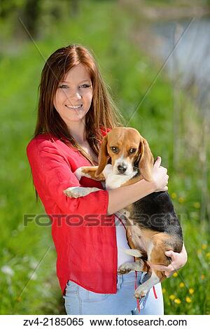 Close-up of a young woman with her Beagle dog in spring. View Large Photo Image Stock Photography - Close-up of a young woman with her Beagle dog in spring.. Fotosearch