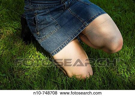 Close-up of a young woman's midsection at a park. View Large Photo Image Stock Photo - Close-up of a young woman's midsection at a park.. Fotosearch