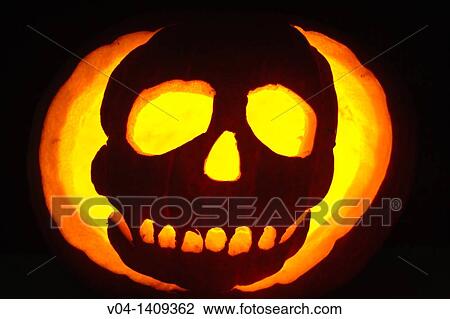 Close up of an illuminated Halloween pumpkin showing a skull View Large Photo Image Stock Image - Close up of an illuminated Halloween pumpkin showing a skull. Fotosearch