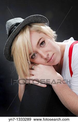 close up of blond model in hat leaning her head on her knee View Large Photo Image Stock Photo - close up of blond model in hat leaning her head on her knee. Fotosearch