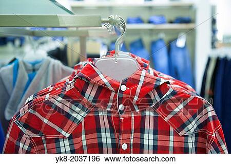 Close-up of blouse, shirt on hanger. Rack, colorful clothing. Fashion in retail store, shop. View Large Photo Image Stock Photograph - Close-up of blouse, shirt on hanger. Rack, colorful clothing. Fashion in retail store, shop.. Fotosearch
