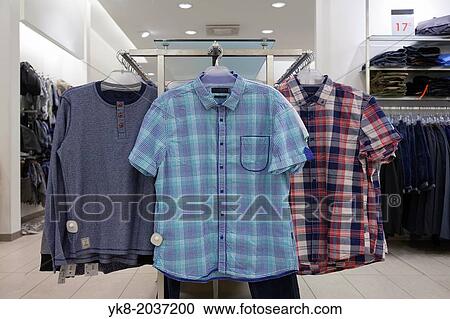 Close-up of blouses, shirts hanging on rack in retail shop. Store interior. View Large Photo Image Stock Image - Close-up of blouses, shirts hanging on rack in retail shop. Store interior.. Fotosearch