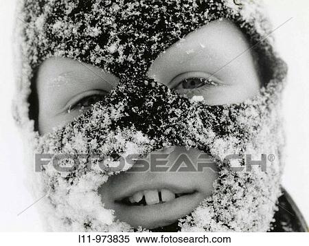 Stock Photography - Close-up of boy in ski mask, covered with snow.. Fotosearch