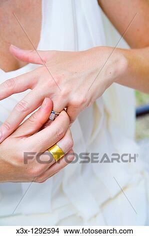 Close-up of bride putting wedding ring on View Large Photo Image Picture - Close-up of bride putting wedding ring on. Fotosearch