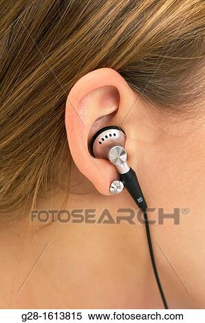 Stock Photography - Close up of Ear of teenager with headphones detail. Fotosearch