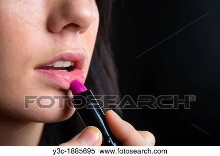 Close up of face section of female teenager, dark hair, applying lipstick, 18 years, Caucasian View Large Photo Image Stock Photography - Close up of face section of female teenager, dark hair, applying lipstick, 18 years, Caucasian. Fotosearch