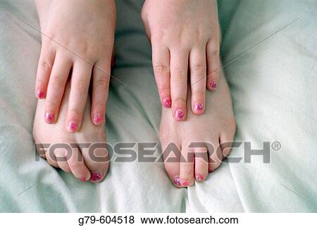 Close up of feet and hands of young girl wearing pink nail polish View Large Photo Image Stock Photo - Close up of feet and hands of young girl wearing pink nail polish. Fotosearch