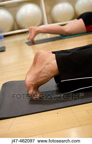 Close-up of feet in pilates class legs stretched out behind View Large Photo Image Stock Photo - Close-up of feet in pilates class legs stretched out behind. Fotosearch