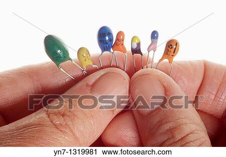 close up of fingers holding a series of diodes View Large Photo Image Stock Image - close up of fingers holding a series of diodes. Fotosearch