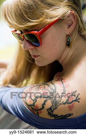 Stock Image - Close-up of Girl with Tattoo on Shoulder - Cedar Mountain, North Carolina USA. Fotosearch