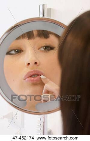Close up of girls face in round mirror. View Large Photo Image Picture - Close up of girls face in round mirror.. Fotosearch