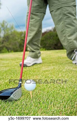 Stock Photo - Close up of golf driver and ball on tee. Fotosearch