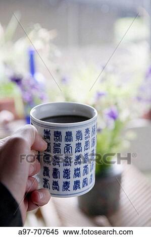 Close-up of hand holding asian style coffee cup. View Large Photo Image Stock Photography - Close-up of hand holding asian style coffee cup.. Fotosearch