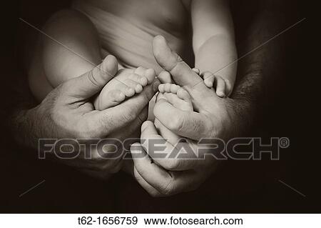 Close up of hands and feet of father and son View Large Photo Image Stock Photo - Close up of hands and feet of father and son. Fotosearch