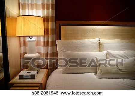 Stock Photograph - Close Up of King Size Bed and Night Stand in a Luxury Las Vegas, NV Hotel.. Fotosearch