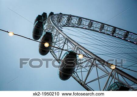 Close up of light bulbs and London Eye at dusk, London, UK View Large Photo Image Stock Image - Close up of light bulbs and London Eye at dusk, London, UK. Fotosearch