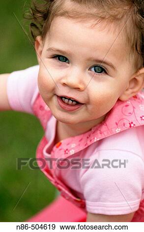 Close-up of little girl in pink overalls View Large Photo Image Stock Photo - Close-up of little girl in pink overalls. Fotosearch