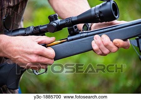 Close up of loading a hunting rifle firearm gun with ammunition bullets View Large Photo Image Stock Image - Close up of loading a hunting rifle firearm gun with ammunition bullets. Fotosearch