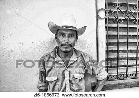 Close up of local man with cowboy hat with colorful wall in Copan Ruinas Honduras downtown city action View Large Photo Image Stock Image - Close up of local man with cowboy hat with colorful wall in Copan Ruinas Honduras downtown city action. Fotosearch