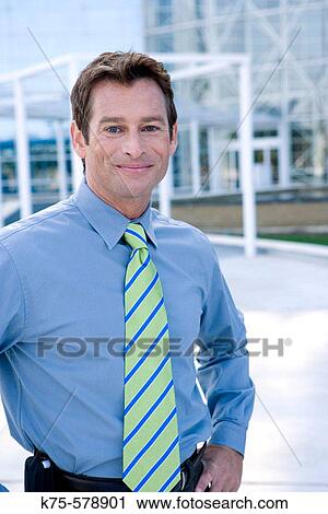 Close up of man outside modern office building View Large Photo Image Stock Image - Close up of man outside modern office building. Fotosearch