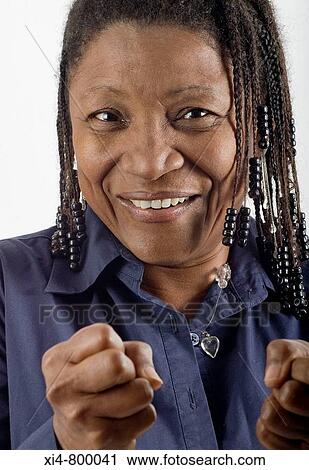 Close up of mature African hispanic woman, with closed fist in first plane. View Large Photo Image Stock Image - Close up of mature African hispanic woman, with closed fist in first plane.. Fotosearch