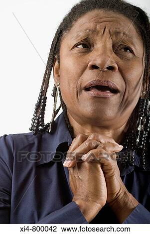 Close up of mature African hispanic woman, with crossed hands near her face. View Large Photo Image Stock Image - Close up of mature African hispanic woman, with crossed hands near her face.. Fotosearch