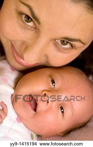 Close-up of Mother and Baby daughter smiling - Lake San Pablo, near Otavalo, Ecuador View Large Photo Image Picture - Close-up of Mother and Baby daughter smiling - Lake San Pablo, near Otavalo, Ecuador. Fotosearch