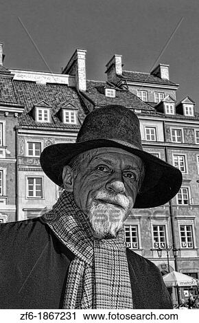 Close up of older man who plays old fashioned music in Main Old Town Main Square Warsaw Poland View Large Photo Image Stock Image - Close up of older man who plays old fashioned music in Main Old Town Main Square Warsaw Poland. Fotosearch