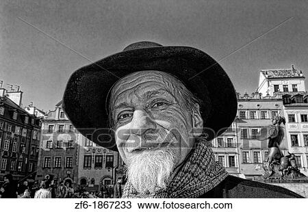 Close up of older man who plays old fashioned music in Main Old Town Main Square Warsaw Poland View Large Photo Image Stock Image - Close up of older man who plays old fashioned music in Main Old Town Main Square Warsaw Poland. Fotosearch