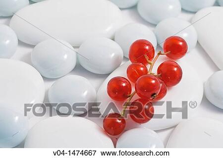Stock Photo - Close-up of red currants on white pebble stones. Fotosearch