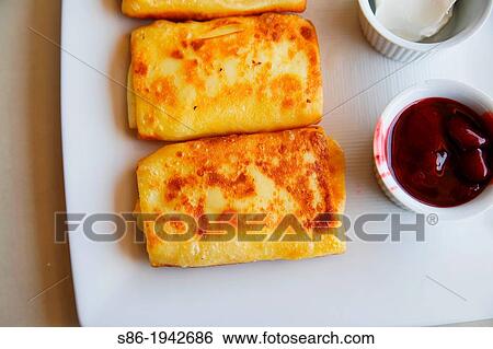Close Up of Rissian Blinis (Blintzed) (Crepes), Accoompanied by Strawberry Preserves and Sour Cream. View Large Photo Image Stock Photograph - Close Up of Rissian Blinis (Blintzed) (Crepes), Accoompanied by Strawberry Preserves and Sour Cream.. Fotosearch