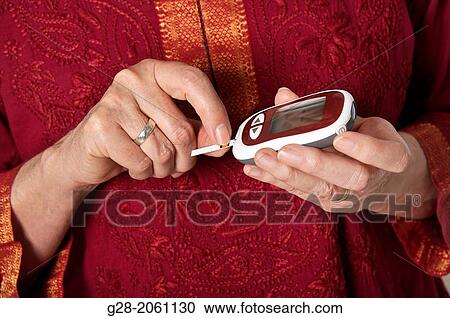 Close up of Senior woman? hands using a blood sugar tester for diabetes View Large Photo Image Stock Image - Close up of Senior woman? hands using a blood sugar tester for diabetes. Fotosearch