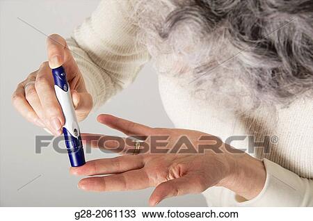 Close up of Senior woman? hands using a lancet for blood sugar testing for diabetes View Large Photo Image Stock Image - Close up of Senior woman? hands using a lancet for blood sugar testing for diabetes. Fotosearch