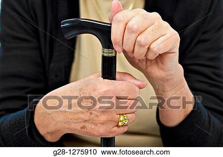 close up of senior woman's hands holding her walking stick View Large Photo Image Stock Image - close up of senior woman's hands holding her walking stick. Fotosearch
