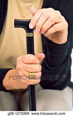 close up of senior woman's hands holding her walking stick View Large Photo Image Stock Photo - close up of senior woman's hands holding her walking stick. Fotosearch