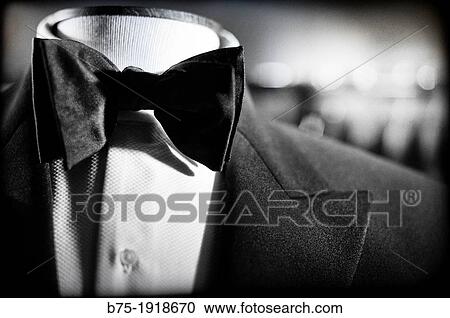 Close-up of suit with white shirt and bow tie on a mannequin View Large Photo Image Stock Image - Close-up of suit with white shirt and bow tie on a mannequin. Fotosearch