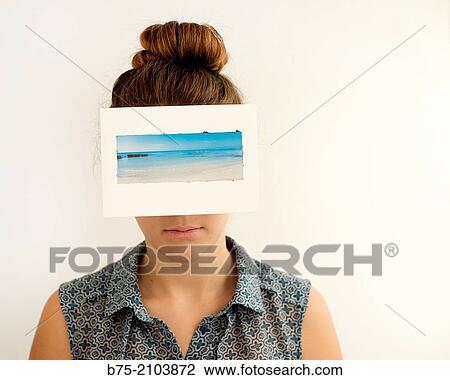 Close-up of teenager girl with peaceful expression and a photograph of the sea covering her face. View Large Photo Image Stock Image - Close-up of teenager girl with peaceful expression and a photograph of the sea covering her face.. Fotosearch