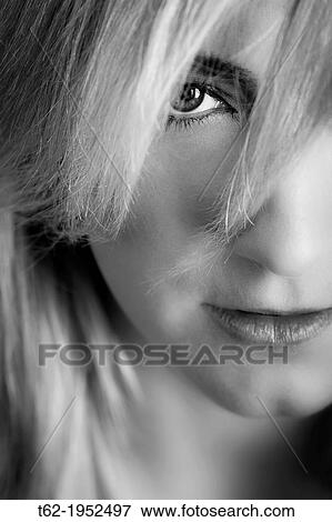 Stock Photo - Close up of the eye of a young attractive caucasian woman, black and white.. Fotosearch