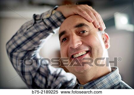 Close-up of the face of a 40-year-old Caucasian man, smiling and with positive attitude, with one hand on his head and wearing plaid shirt. View Large Photo Image Stock Photography - Close-up of the face of a 40-year-old Caucasian man, smiling and with positive attitude, with one hand on his head and wearing plaid shirt.. Fotosearch