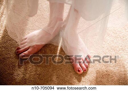 Close-up of the feet of a young woman who is wearing a prom dress View Large Photo Image Picture - Close-up of the feet of a young woman who is wearing a prom dress. Fotosearch