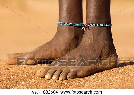 Picture - Close-up of the feet of an Hamer girl in Turmi, Lower valley of the Omo river, Ethiopia, Africa. Fotosearch