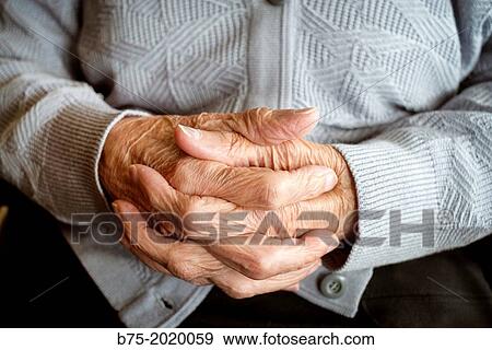 Stock Photo - Close up of the hands of a centennial woman in a elderly people home.. Fotosearch