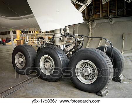 Stock Photo - Close up of the wheels of an airplane in a maintenance aviation facility at the SIA Engineering Company in Singapore. Fotosearch